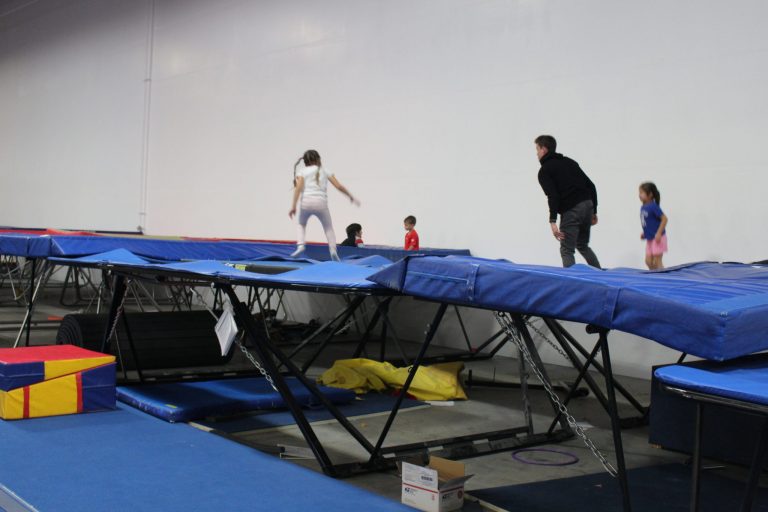 Kids jumping on trampolines with a coach at High Altitude Tumbling in Provo